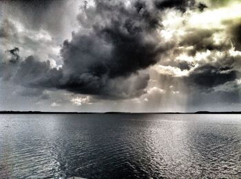 Scenic view of sea against cloudy sky