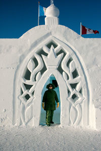 Full length of man standing outside building against sky