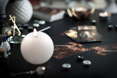 Esoteric magic objects and tarot cards on witch table altar for mystic rituals and fortune telling.