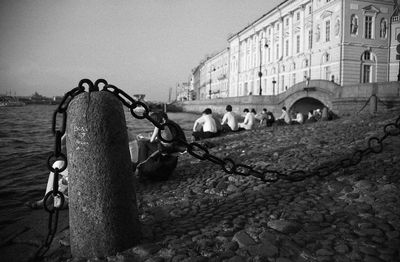 People in front of old building against clear sky