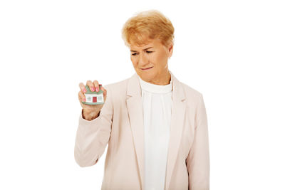 Man holding ice cream against white background