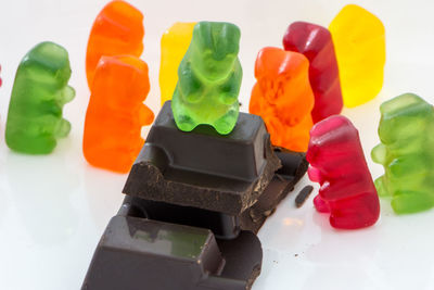 Close-up of multi colored candies against white background