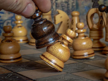 Close-up of hand holding chess pieces