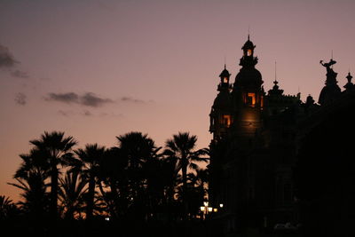 Low angle view of silhouette building against sky during sunset