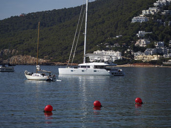 Boats moored in calm blue sea