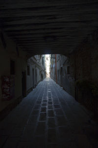 Empty alley amidst buildings in city