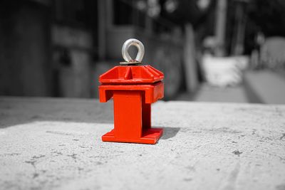 Close-up of red toy on footpath