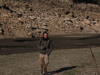 Portrait of man standing on landscape