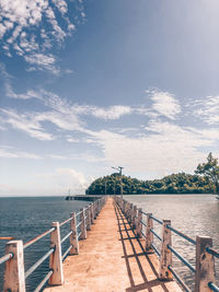 Pier over sea against sky