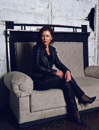 Portrait of woman sitting on sofa