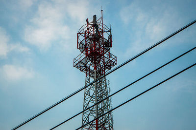 Low angle view of communications tower against sky