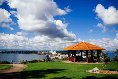 Built structure by sea against sky