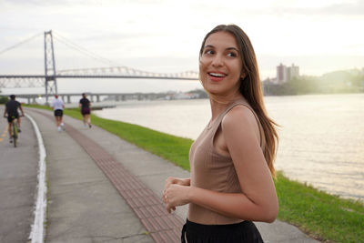 Portrait of young woman standing on road