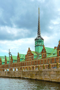 Spire of borsen building, shaped as tails of dragons twined together in twiligh. copenhagen, denmark