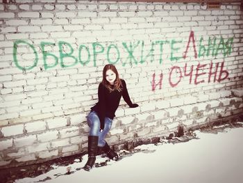 Portrait of woman on brick wall