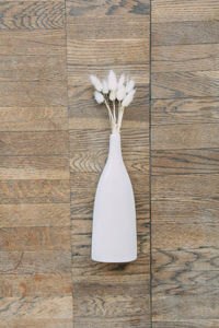 Directly above shot of white flower vase on table