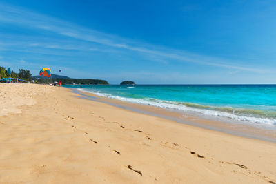 Scenic view of beach against blue sky