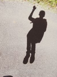 High angle view of silhouette man holding shadow