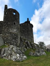 Low angle view of historic building against cloudy sky