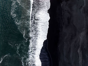 Iceland black sand beach with huge waves at reynisfjara vik.