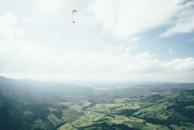 Hot air balloons flying over landscape