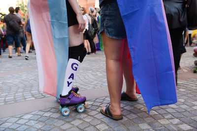 Low section of people walking on street