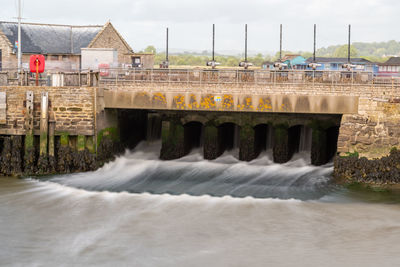 Long exposure of the river brit flowing into the harbour at west bay in dorset