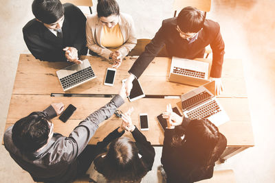 High angle view of people sitting on table