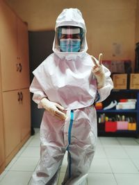 Man wearing protective suit standing indoors