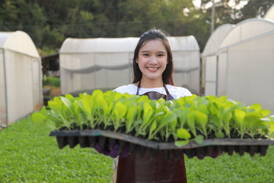 Portrait of a smiling young woman standing outdoors