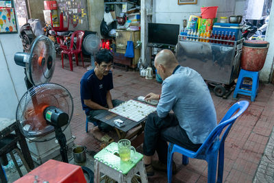 High angle view of people working on table