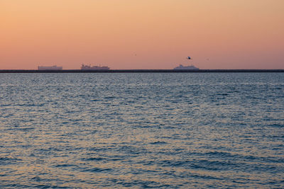 Scenic view of sea against orange sky