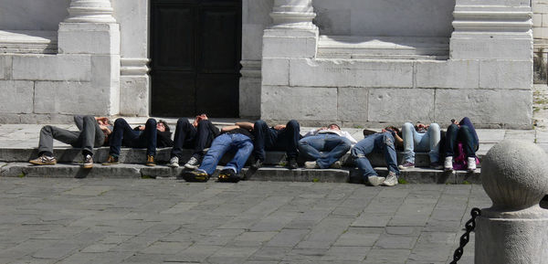 People resting on pavement