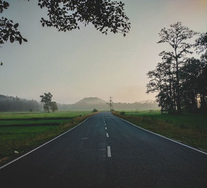 Empty road along countryside landscape