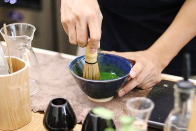 Midsection of person preparing food on table