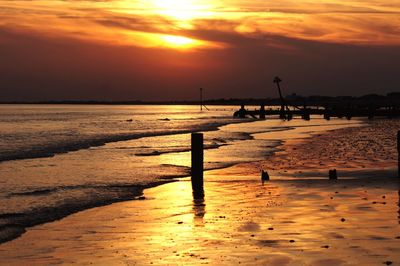 Scenic view of beach against sky during sunset