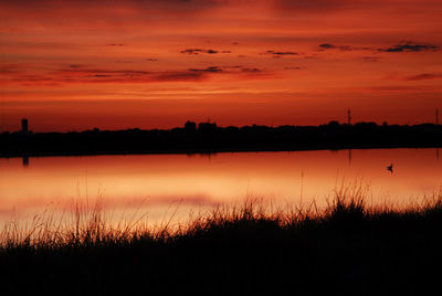 Scenic view of lake against romantic sky at sunset