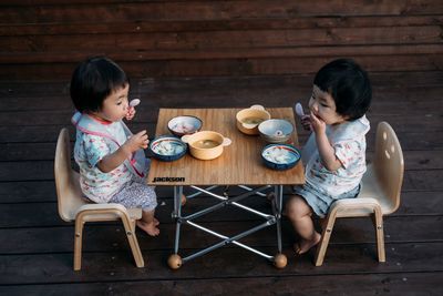 Portrait of mother and son sitting on ground