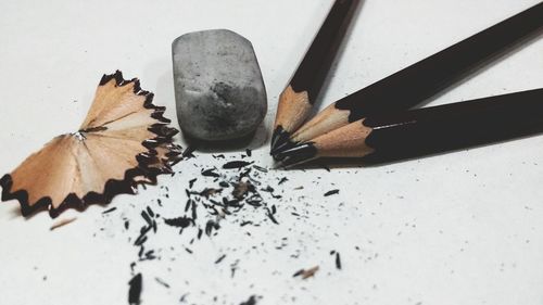 High angle view of pencils and eraser on gray background