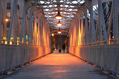 Illuminated walkway in city