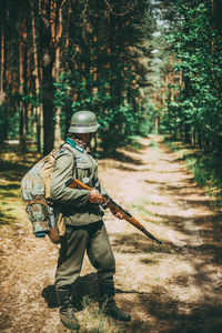 Rear view of man walking in forest