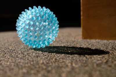 Close-up of blue rug on sand