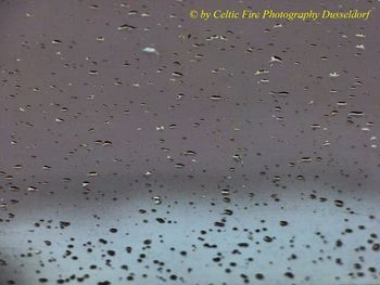 Full frame shot of wet glass window during rainy season