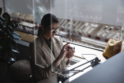 Side view of woman using mobile phone