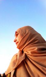 Low angle view of woman against clear sky