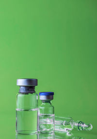 Close-up of green bottles against blue background