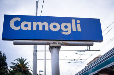 Low angle view of road sign against sky