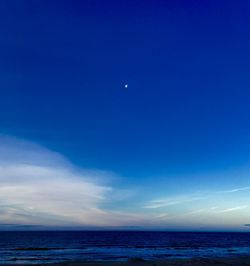 Scenic view of sea against blue sky