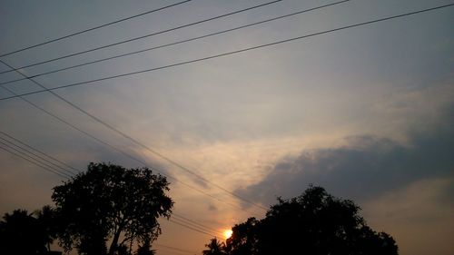 Low angle view of silhouette trees against sky at sunset