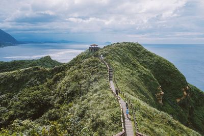 High angle view of sea and mountains against sky